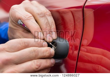 Close-up Of Person Hand Holding Lockpicker To Open Car Door
** Note: Shallow depth of field