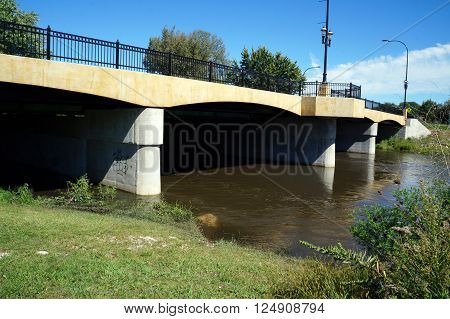 PLAINFIELD, ILLINOIS / UNITED STATES - SEPTEMBER 20, 2015: The DuPage River flows under a bridge in downtown Plainfield.