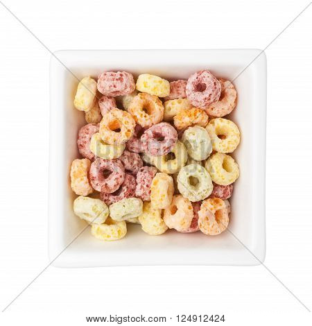Colorful breakfast cereal in a square bowl isolated on white background