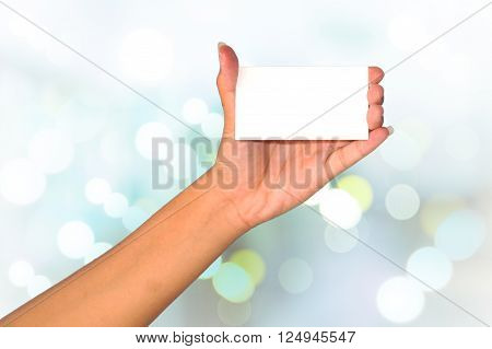 Hand holding empty white paper isolated on white background.