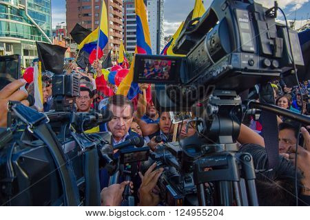 Quito, Ecuador - April 7, 2016: Closeup opposition leader Andres Paez surrounded by people, police and journalists during anti government protests in Shyris Avenue.