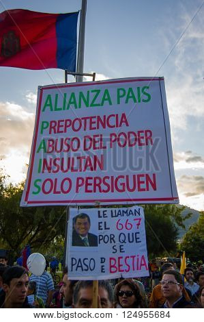 Quito, Ecuador - April 7, 2016: Group of people Holding protest signs, police and journalists during anti government protests in Shyris Avenue.