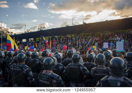 Quito, Ecuador - April 7, 2016: Police awaiting overlooking peaceful anti government protests in Shyris Avenue, beautiful blue sky and buildings background.