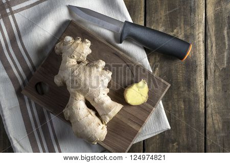 Fresh ginger root on a cutting board from above