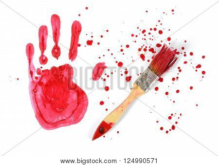 A paint brush and gouache red handprint on white canvas background in top view. Art composition.