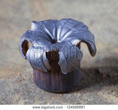 Copper plated lead hollow point bullet that has hit a target
