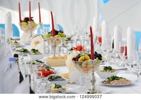 Festive table for celebration. Banquet table with Cutlery and tableware. Table with white tablecloth served to guests. The table in the restaurant. Luxury Desk for the celebration.