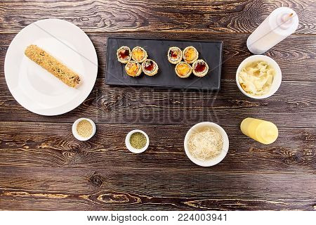 Cut and uncut rolls unagi furay and side dish. Appetizing set of japanese sushi on plate. Asian traitional food.