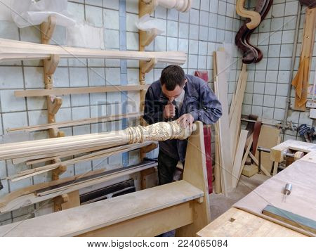 ST. PETERSBURG, RUSSIA - AUGUST 8, 2017: Worker making harp in Resonance Harps enterprise. The company revives the production of harps of the Lunacharsky factory founded in 1947
