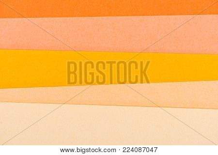 close-up shot of orange shades paper layers for background