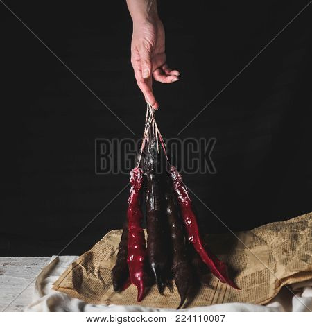cropped shot of woman holding traditional geoogian desserts churchchel