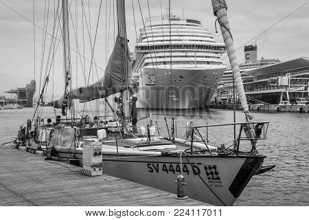 Savona, Italy - December 2, 2016: Yacht and cruise ship moored in harbor at the Ligurian sea port in Savona, Italy. Black and white photography.