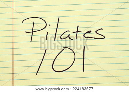 The words Pilates 101 on a yellow legal pad