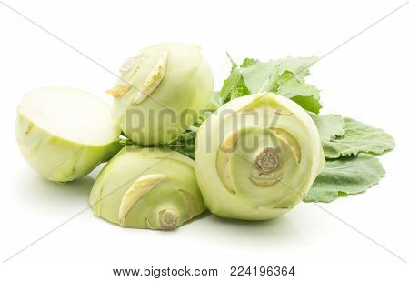 Kohlrabi (German turnip or turnip cabbage) with fresh leaves isolated on white background two bulbs and one cut in half