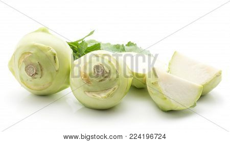 Kohlrabi (German turnip or turnip cabbage) set with fresh leaves isolated on white background two raw bulbs two slices and one half