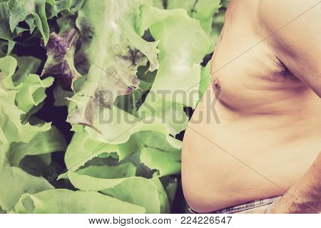 Fat Man And Vegetable On A Background