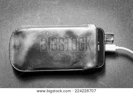 Smartphone With Charger On A Black Background