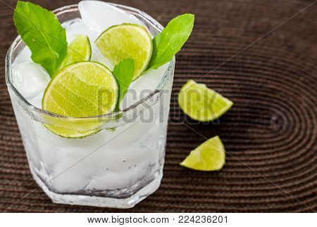 Cocktail With Lime On A Wooden Table