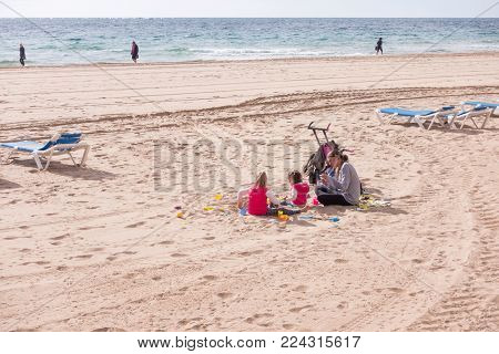 Benidorm, Spain - January 14, 2018: Family enjoying holiday in popular spanish resort Benidorm, Costa Blanca, Spain.