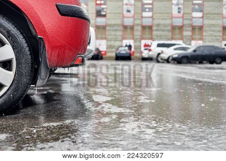 Closeup photo of frozen icy car on parking lot