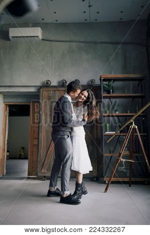 A cheerful couple is having fun together and dance. Artwork. Selective, soft focus
