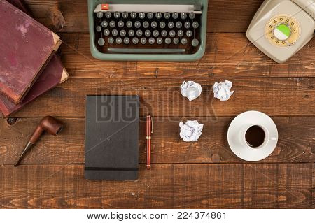 old retro journalist desktop with tablet, typewritter and telephone