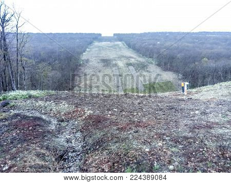 A clearing in the forest for the gas pipeline. Underground gas pipeline.