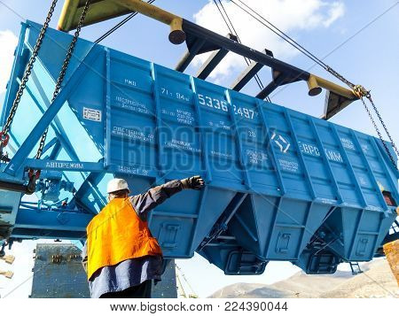 Novorossiysk, Russia - October 10, 2017: Wagon of the hopper for unloading on a cargo ship. Lifting operations in the port.