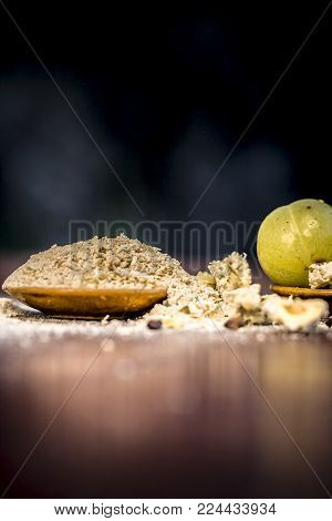 Raw Fresh Ripe Phyllanthus Emblica,amla Or Indian Gooseberry With Its Powder On Wooden Surface.