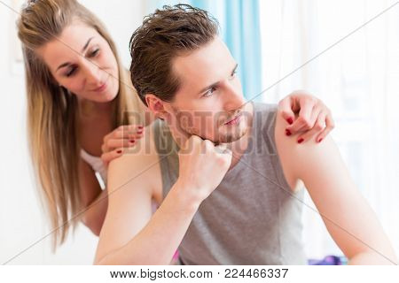 Quarreling young couple, man is huffy and remains silent