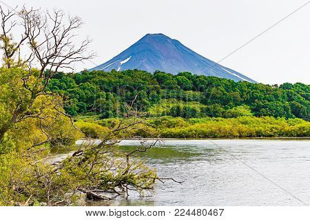 Kurile lake. Kamchatka. Russia. Wild nature Green fields and volcanoes