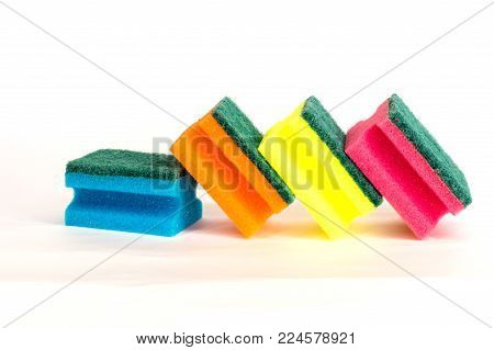 multicolored sponges for washing dishes on white background