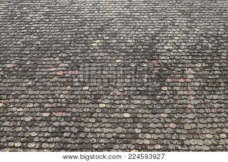 Medieval church roof top covered with shingles
