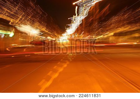 Blured night street traffic scene under city lights