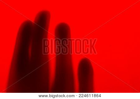 Fingers silhouette on red background artistic scene