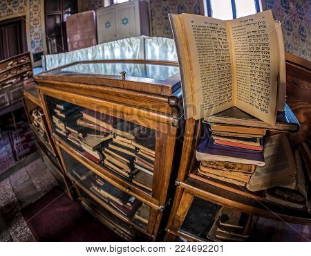 ORADEA, ROMANIA - JANUARY 27, 2018: Inside of one small Orthodox Synagogue with lots of books in the Hebrew language.