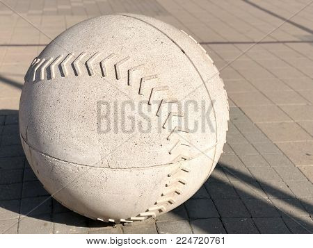 Fancy traffic restriction concrete barrier made to resemble a baseball game ball