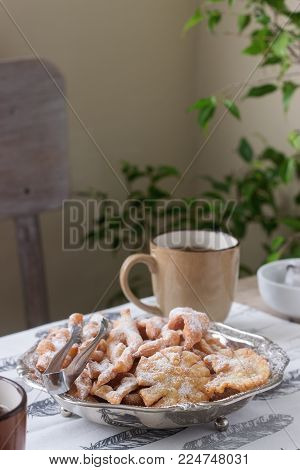 Angel wings biscuits, a traditional European sweet dish for carnival. Rustic style, selective focus.