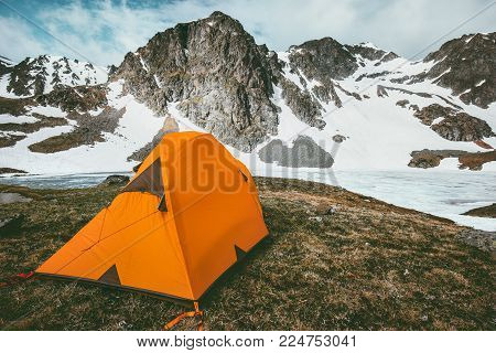 Orange camping tent in Mountains Landscape Travel Lifestyle concept adventure vacations outdoor hiking gear equipment