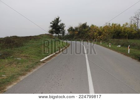 Curvi road in countryfield surrounding during autumn time
