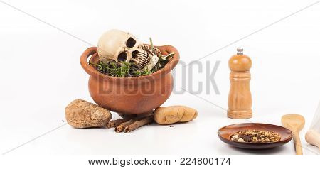 Boiled Skull In Clay Pot With Some Herb On White Background