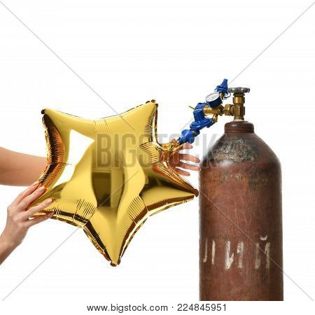 Hands inflate gold star balloon use Helium Tank with Economy Regulator Fill Valve for Latex Balloons isolated on white background
