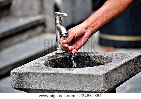 holy water flowing through the tap of gerogian church