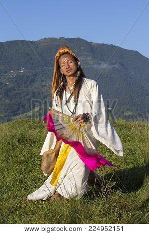 Sirena Sabiha dancing with a fan at sunrise in Pokhara, Nepal. Sirena was born in the Philippines. Close up