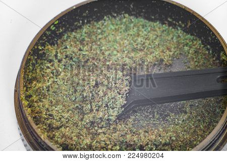 Kief In Grinder For Weed Macro Top View Isolated On White Background