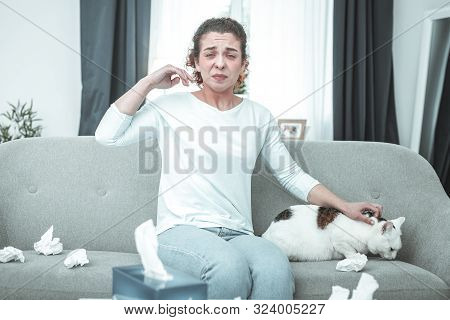Woman Wearing Jeans Sneezing Having Intolerance To Cats