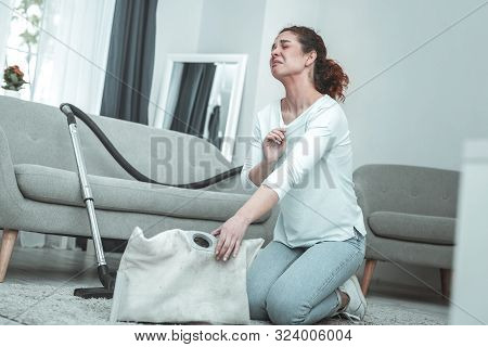 Curly Red-haired Woman Feeling Awful While Using Vacuum Cleaner