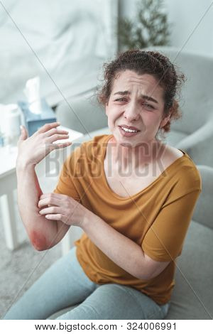 Curly Red-haired Woman Having Much Pain After Car Accident