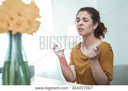 Woman Sneezing And Taking Pill While Having Allergy To Flowers