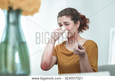 Woman Wearing Orange Shirt Drying Nose Suffering From Allergy